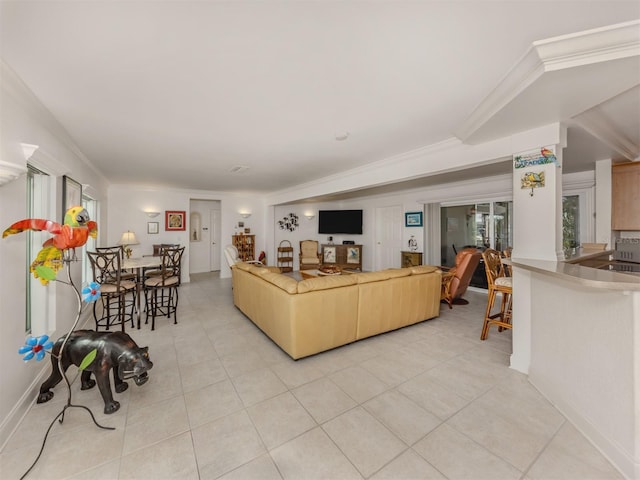 living area with light tile patterned floors and crown molding