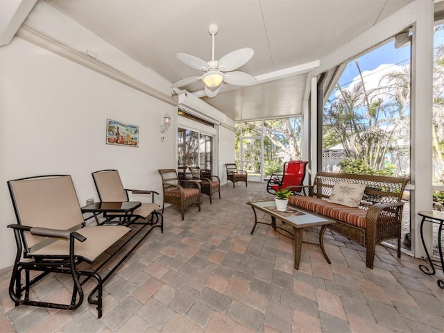 sunroom / solarium with plenty of natural light and ceiling fan