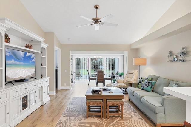 living room with ceiling fan, light hardwood / wood-style floors, and vaulted ceiling