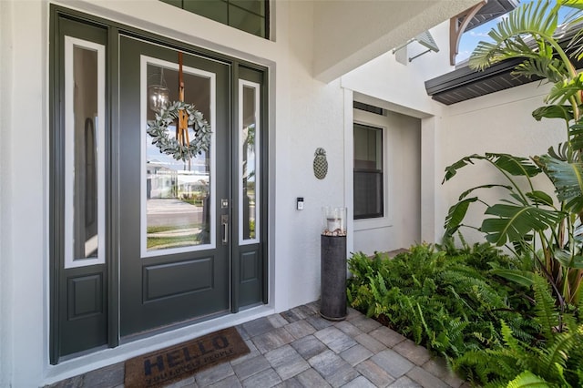 entrance to property with stucco siding