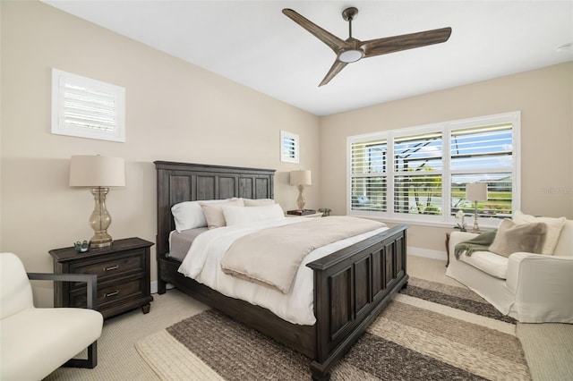 bedroom with baseboards, a ceiling fan, and light colored carpet