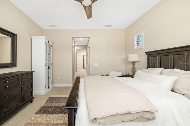 bedroom with visible vents, ceiling fan, light carpet, and baseboards