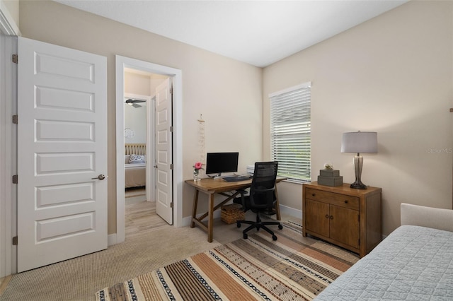 bedroom with light colored carpet and baseboards