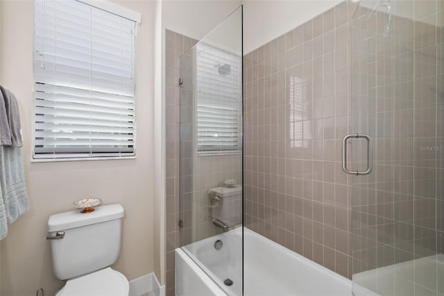 full bathroom with bath / shower combo with glass door and toilet