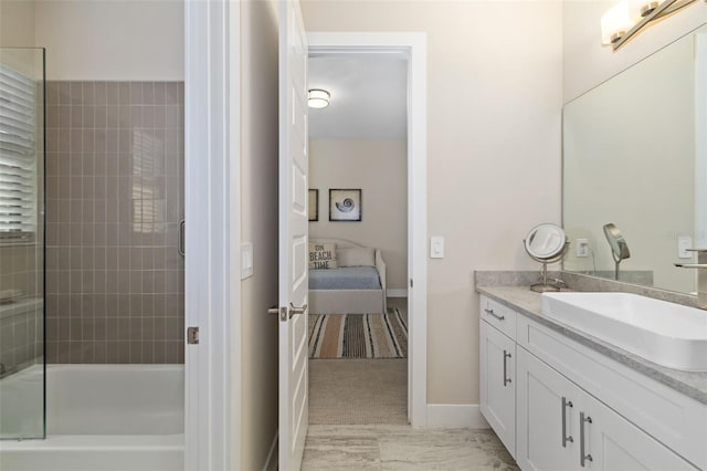 ensuite bathroom featuring shower / bathtub combination, baseboards, vanity, and ensuite bathroom