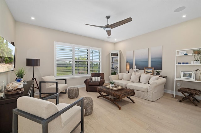 living area featuring recessed lighting, baseboards, ceiling fan, and light wood finished floors