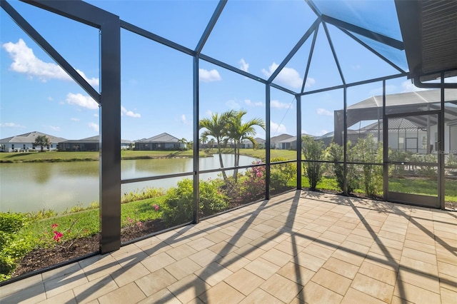 unfurnished sunroom with a water view