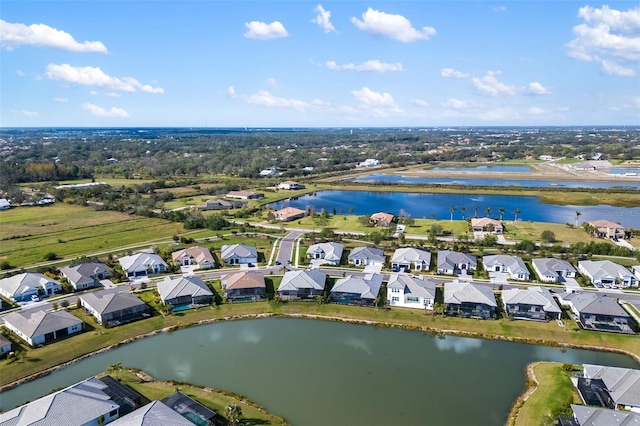 drone / aerial view with a residential view and a water view