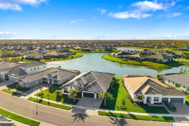 bird's eye view featuring a residential view and a water view