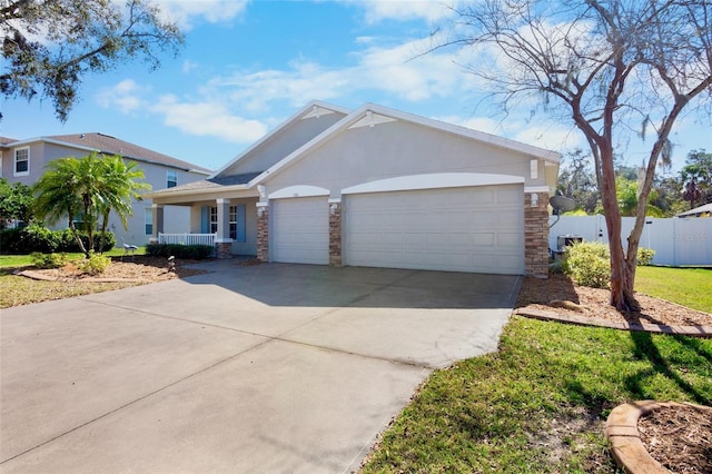 ranch-style home with a garage and covered porch