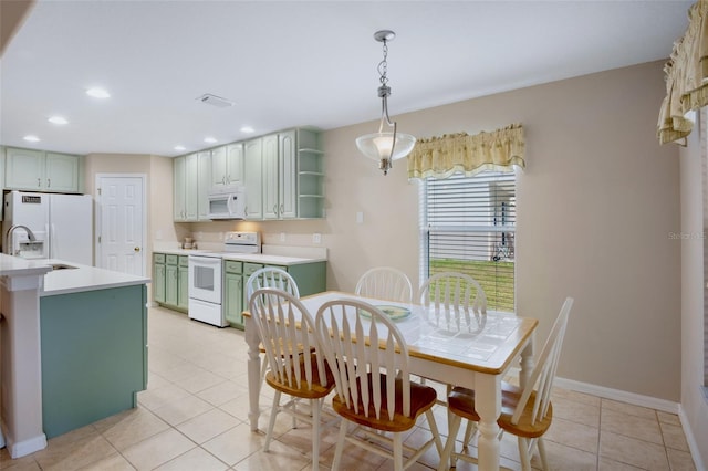 dining area with light tile patterned floors and sink