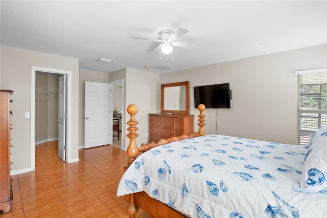 bedroom featuring a spacious closet, ceiling fan, and a closet