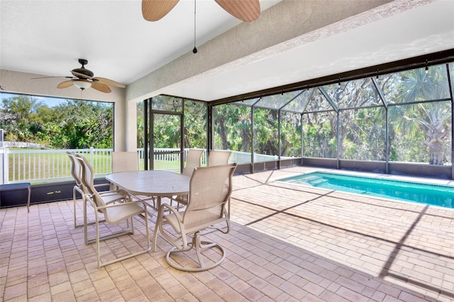 view of pool featuring a patio area, ceiling fan, and glass enclosure