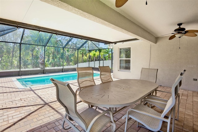 view of patio / terrace featuring ceiling fan, a fenced in pool, and glass enclosure