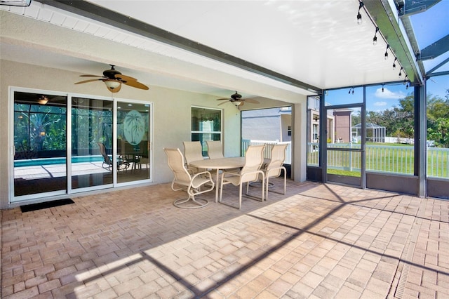 unfurnished sunroom featuring beamed ceiling