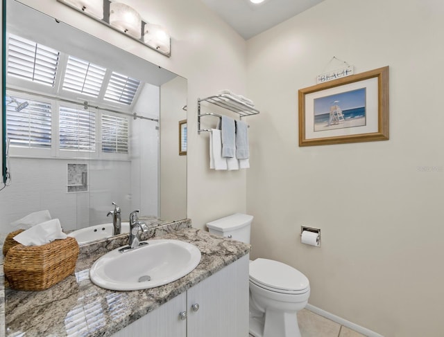 bathroom with tile patterned floors, vanity, and toilet