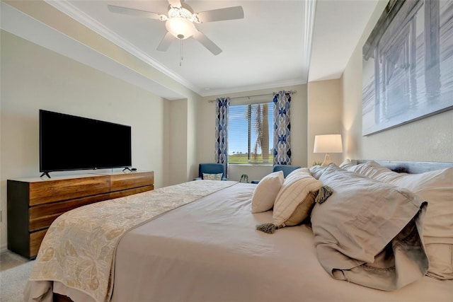 carpeted bedroom featuring crown molding and ceiling fan