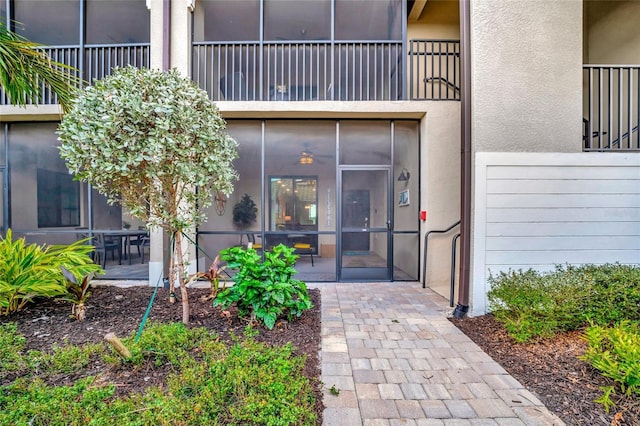 view of exterior entry featuring a balcony