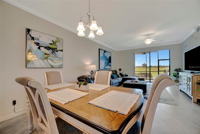 tiled dining room featuring crown molding and ceiling fan with notable chandelier