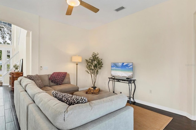 living room with dark hardwood / wood-style floors and ceiling fan