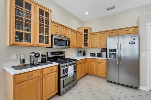 kitchen featuring appliances with stainless steel finishes and light tile patterned floors