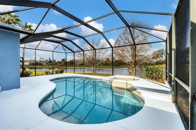 view of pool with an in ground hot tub, glass enclosure, a patio area, and a water view