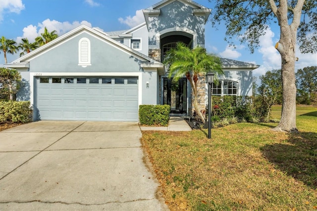 view of front of property featuring a garage and a front lawn