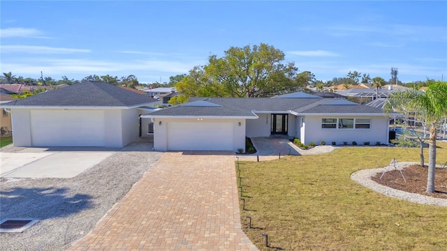 ranch-style home with a front lawn and a garage