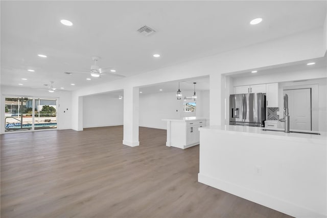 1950 Fairview Dr, Englewood, FL 34223 - unfurnished living room featuring sink, ceiling fan, and wood-type flooring