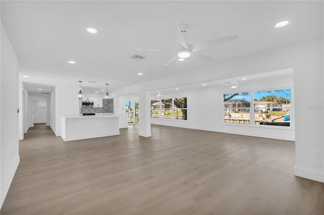 1950 Fairview Dr, Englewood, FL 34223 - unfurnished living room with hardwood / wood-style flooring and ceiling fan