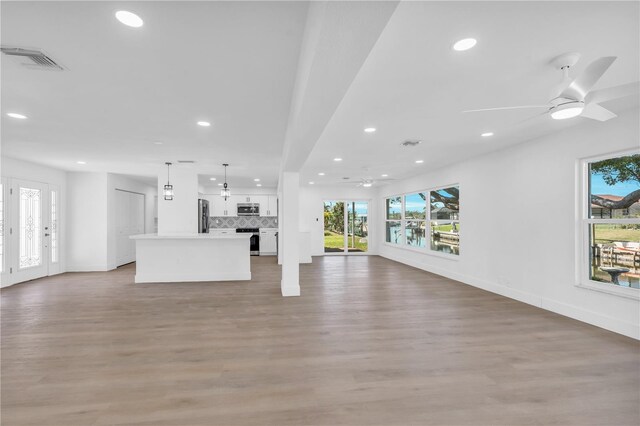 1950 Fairview Dr, Englewood, FL 34223 - unfurnished living room with ceiling fan and light wood-type flooring