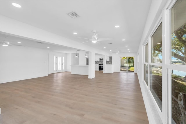 1950 Fairview Dr, Englewood, FL 34223 - unfurnished living room featuring light wood-type flooring and ceiling fan