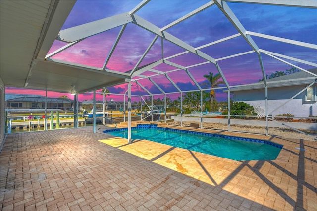 1950 Fairview Dr, Englewood, FL 34223 - pool at dusk featuring a patio and a lanai