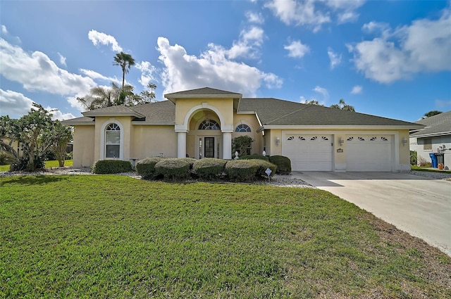 view of front of house featuring a garage and a front lawn