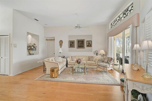 living room featuring ceiling fan and light wood-type flooring