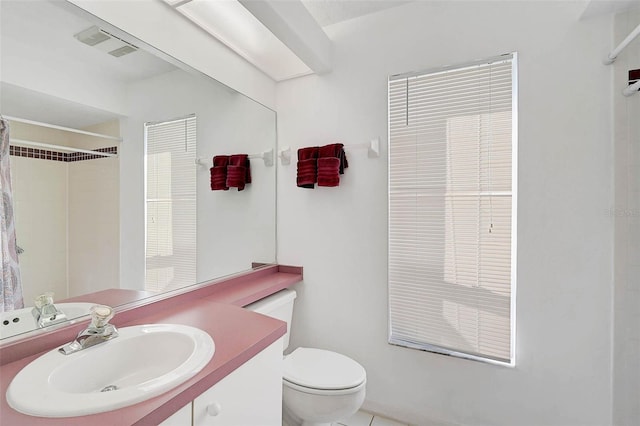 bathroom featuring vanity, a shower with curtain, and toilet