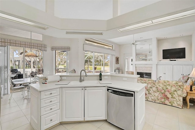 kitchen with a kitchen island with sink, sink, white cabinetry, and dishwasher