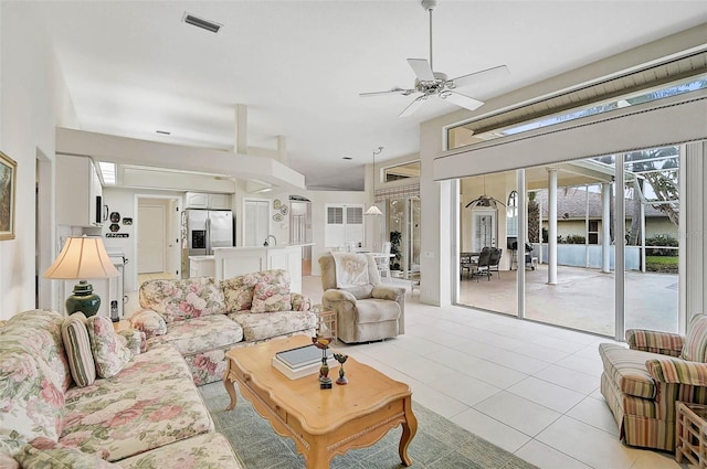 tiled living room with ceiling fan