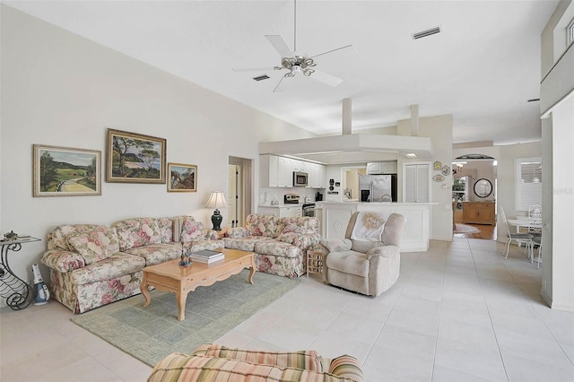 living room featuring vaulted ceiling, light tile patterned floors, and ceiling fan