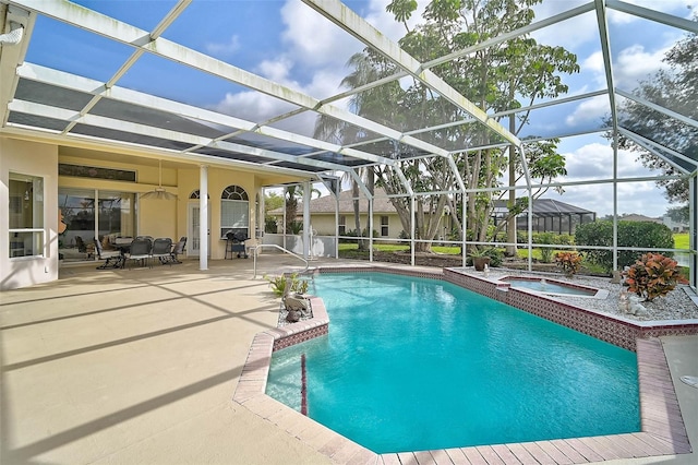 view of swimming pool with a lanai, a patio, and an in ground hot tub