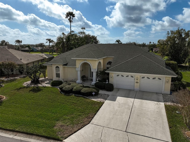 view of front of property with a garage and a front lawn