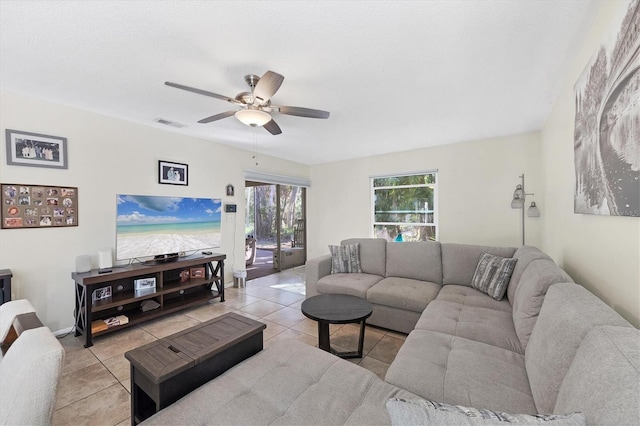 tiled living room with ceiling fan