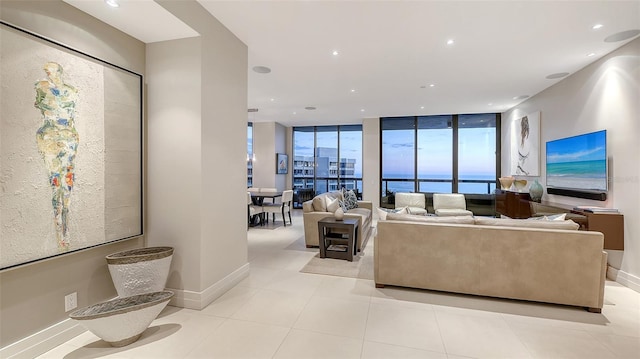 living room featuring floor to ceiling windows and light tile patterned floors