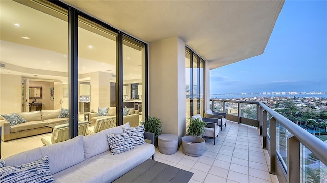 balcony featuring a water view and an outdoor hangout area