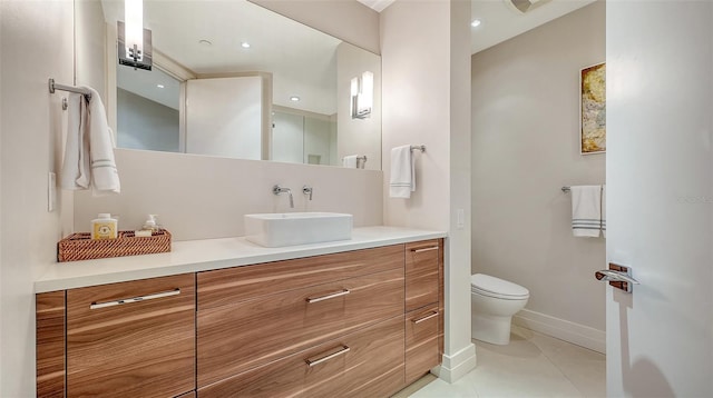 bathroom featuring vanity, toilet, and tile patterned flooring