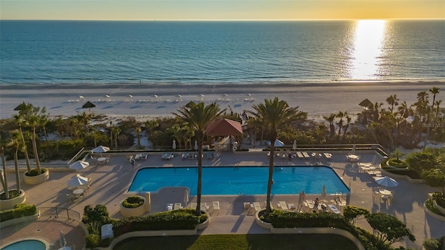 view of pool featuring a patio area and a water view