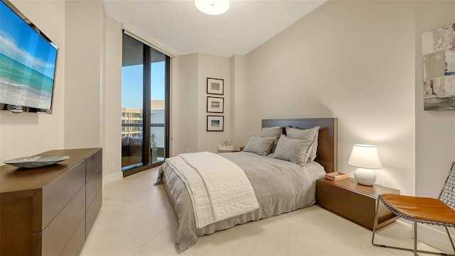 tiled bedroom featuring access to exterior and a wall of windows