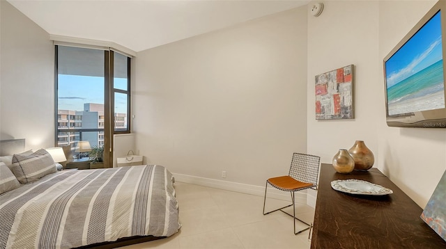 bedroom with light tile patterned floors and floor to ceiling windows