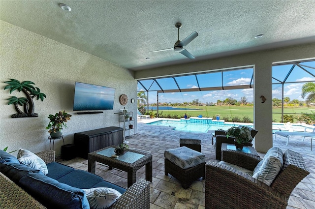 view of patio / terrace featuring a lanai, an outdoor hangout area, and ceiling fan