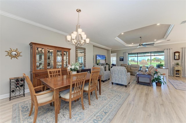 dining area featuring light wood-type flooring, ornamental molding, ceiling fan with notable chandelier, and recessed lighting